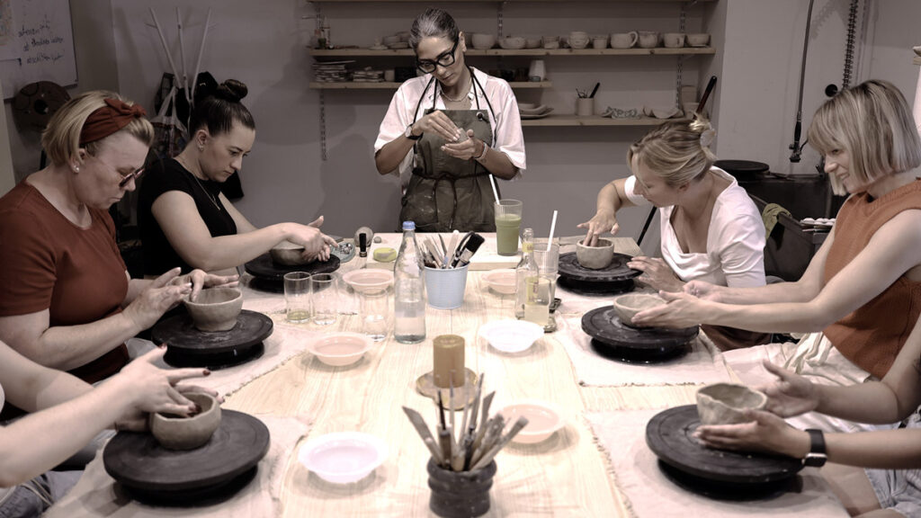 Participants creating handmade ceramics during a pottery workshop event at Dream Pottery Café in Düsseldorf, Germany