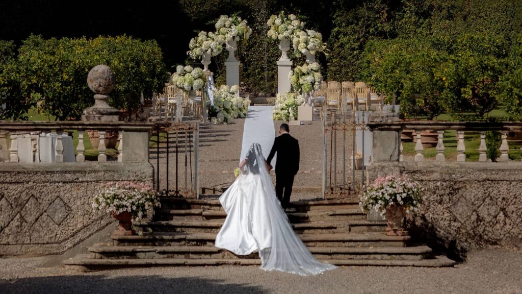 Bride and groom walking toward their Persian wedding ceremony
