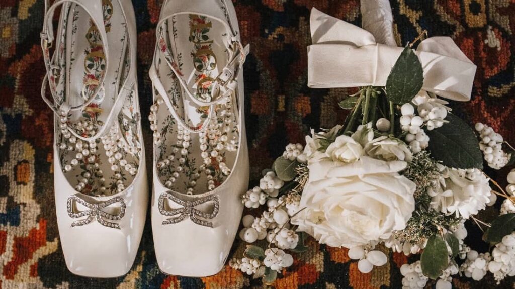 Wedding details featuring bridal shoes, jewelry, and flowers at a Persian wedding