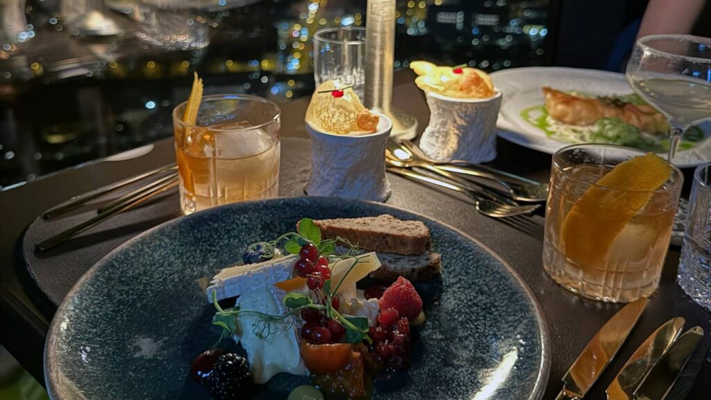 Romantic dessert and drinks during a date night with city views, representing meaningful connections and modern relationships