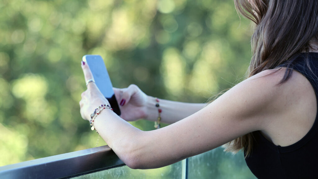 Woman using a smartphone, representing online dating and dating apps for Persian singles