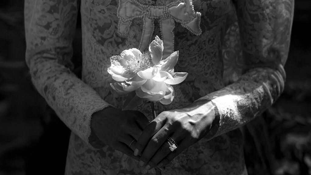 Bride holding flowers, representing engagement and marriage traditions in Persian culture