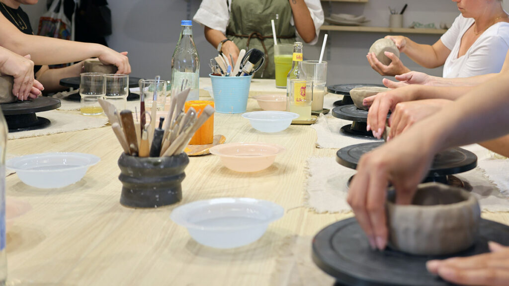 Group of people working together at a shared table during a creative workshop