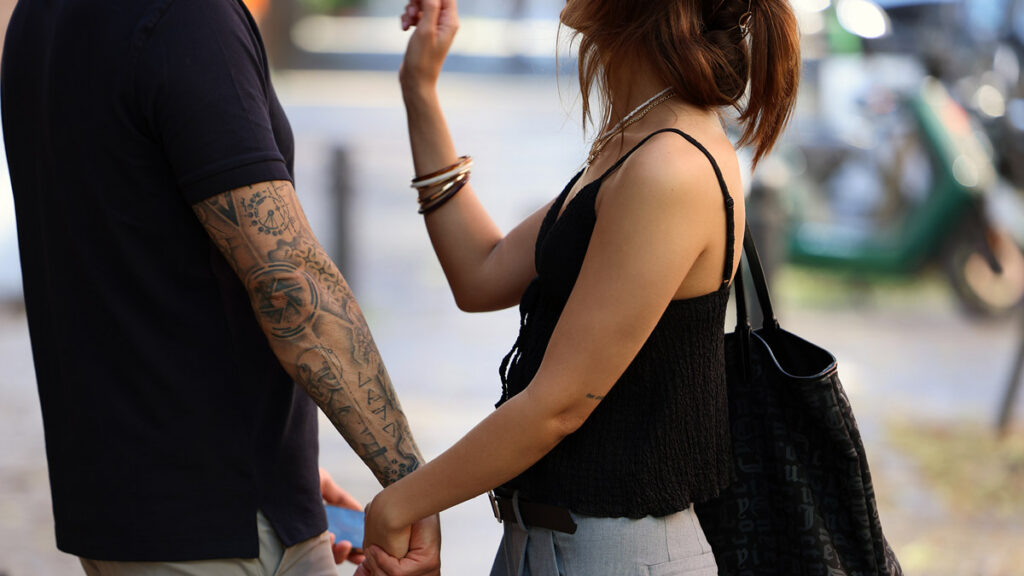 Couple talking closely while walking side by side