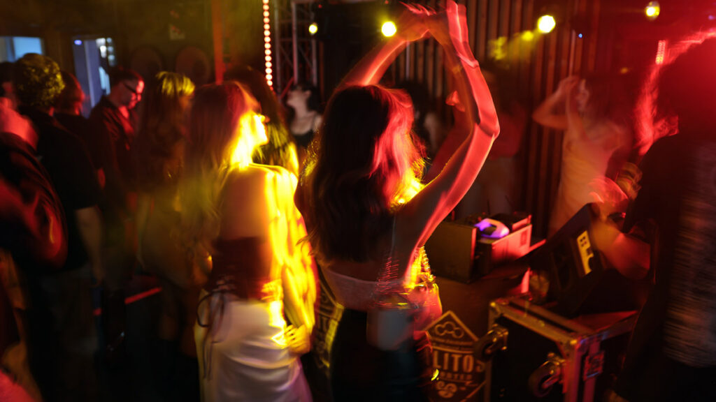 People dancing and enjoying music at an Iranian community party