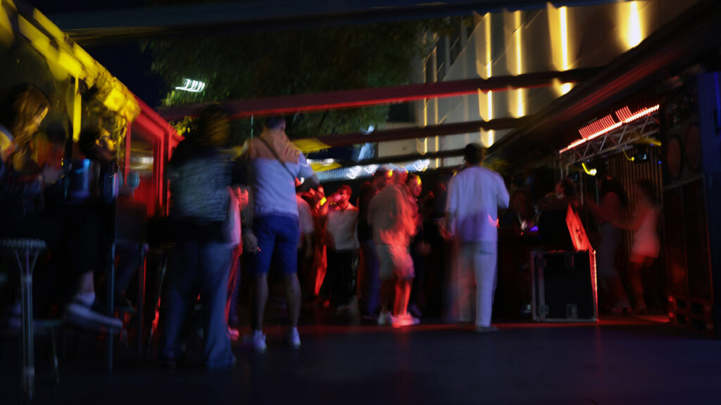 People mingling at an evening community gathering