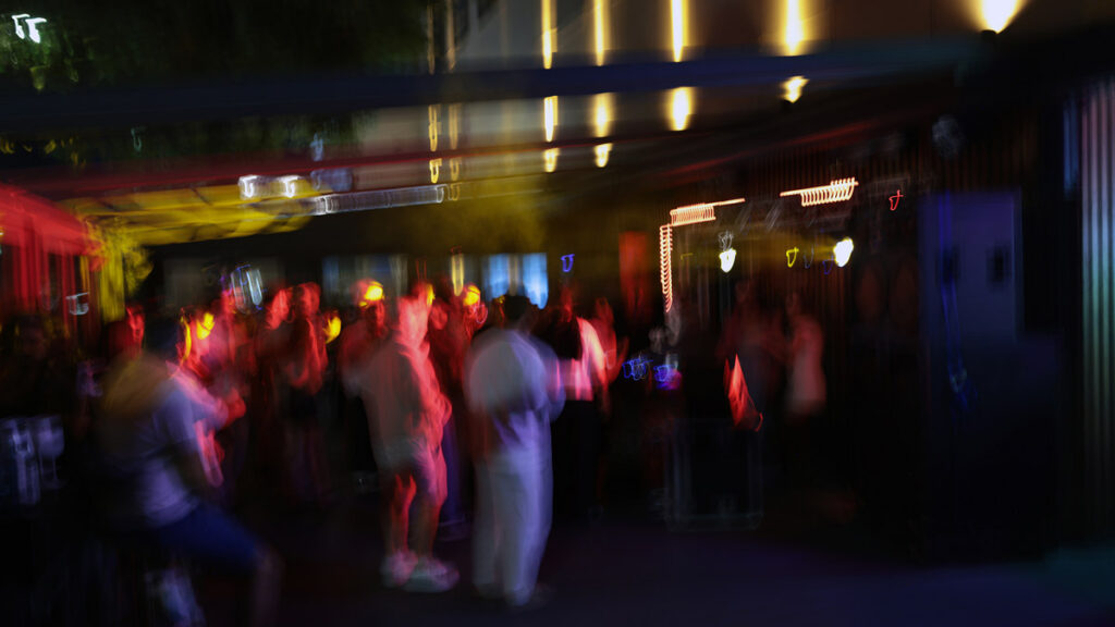 People socialising at an evening gathering